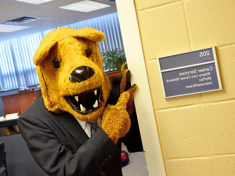 Nittany Lion pointing at the Career Services office sign